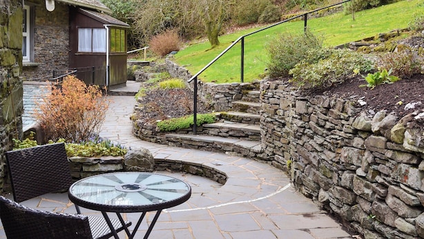 A stone staircase leading to a house with a glass table and chairs outside. - The Coach House - UK30813 (Thornthwaite, near Keswick)
