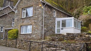 A stone house with a white window and a sign that reads "Coach House". - The Coach House - UK30813 (Thornthwaite, near Keswick)