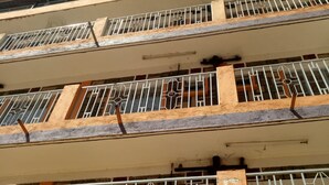 A multi-story building with balconies, each with metal railings and windows. - Yumwema Guest House (Nakuru)