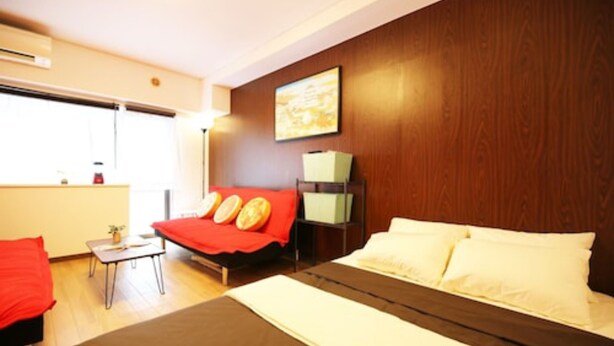 A hotel room with a bed, a desk, a chair, and a small table with a plant. - Lions Mansion Dogenzaka 207 (Tokyo)