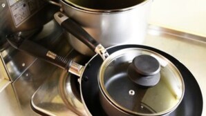 A stainless steel stove with a pot and lid on it. - Lions Mansion Dogenzaka 207 (Tokyo)