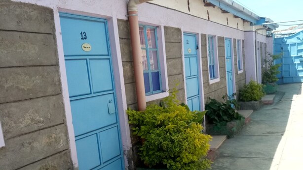 A row of blue doors with numbers, indicating a hotel or motel. - Smartie Guest House (Nakuru)