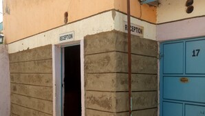 A reception area with a door marked "RECEPTION" and a blue door with the number "17". - Smartie Guest House (Nakuru)