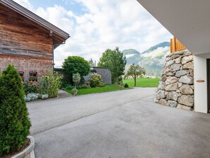 Set amidst a lush garden with a majestic tree, this property offers a serene mountain backdrop.