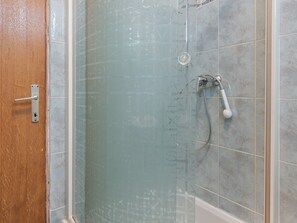 A glass-enclosed shower with a handheld showerhead and a wall-mounted faucet. - Homely Apartment in Vir With Balcony (Vir)