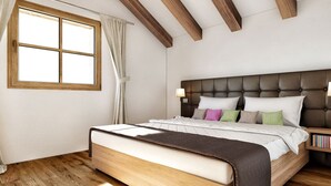 A bedroom with a wooden floor, a large bed with a headboard, a window with curtains, and a nightstand with books. - Cozy Chalet in Weisspriach With Terrace (Weisspriach)