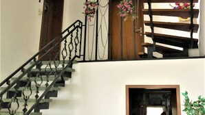 Un escalier avec une rampe en fer forgé et des marches en bois.