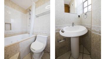 A bathroom with a bathtub, toilet, and sink.
