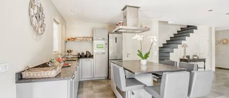 Villa | Private kitchen | Fridge, high chair
