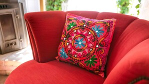 A red armchair with a colorful embroidered pillow. - Villa in Drents-friese Forest With Pool (Wateren)