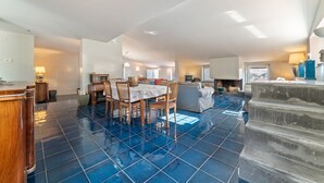 A spacious living area with a dining table, chairs, and a fireplace. - Vintage Holiday Home in Caselle in Pittari near Forest (Caselle in Pittari)