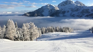 A snow-covered mountain landscape with a clear sky.