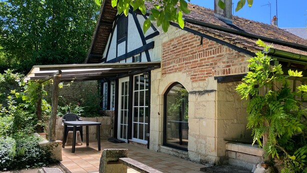 A traditional half-timbered house with a patio, stone bench, and a table. - Charming House with Terrace & Garden, Near La Roche-Posay Town Center (La Roche-Posay)