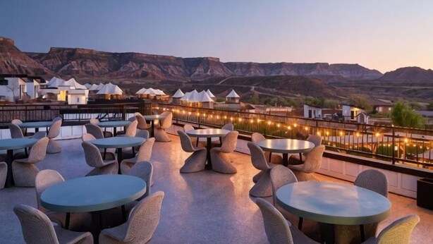 A rooftop terrace with round tables and chairs, overlooking a mountainous landscape. - Zion Wildflower Resort, WorldHotels Backdrop (Virgin)