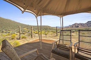 An outdoor seating area with chairs and a canopy, overlooking a desert landscape with sparse vegetation and distant mountains. - Zion Wildflower, BW Premier Collection (Virgin)