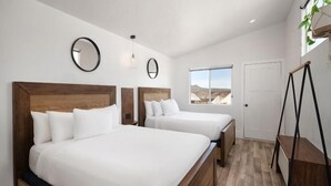 A hotel room with two beds, a large window, and a view of the mountains. - Zion Wildflower Resort, WorldHotels Backdrop (Virgin)