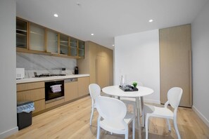Enjoy meals in this kitchen with a stove, dishwasher, and dining table.
