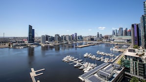 A marina with boats docked, surrounded by modern high-rise buildings. - Central Melbourne 2br2bt APT on Collins St+parking (Docklands)