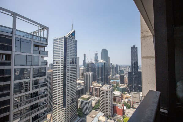 A cityscape with high-rise buildings, including a prominent building with 'AMP' signage.