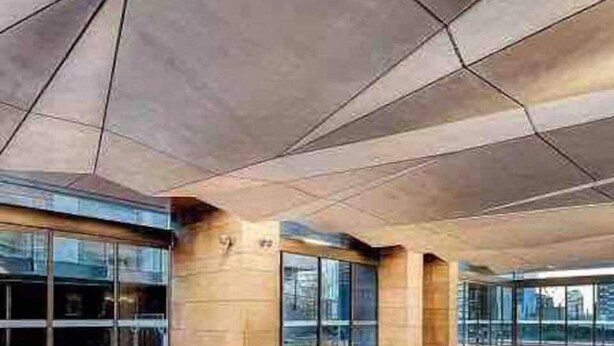 A modern indoor swimming pool with clear glass walls, a tiled floor, and a concrete ceiling. - Cozy Gem With Poolgym in Mel Cbd@southerncross (Melbourne)