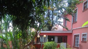 A courtyard with a tiled bench, a small table, and a building in the background.