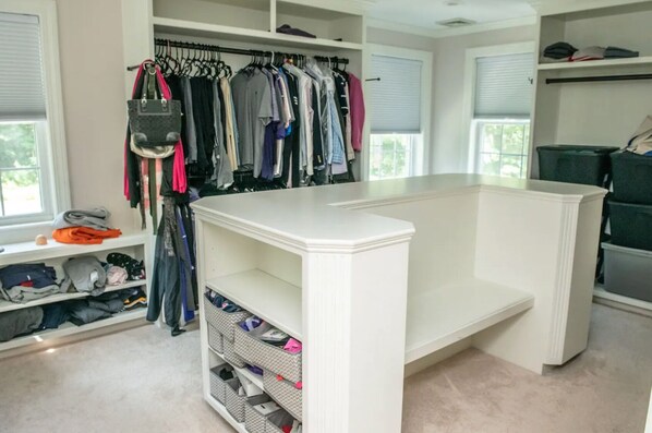 A walk-in closet with a built-in bench, shelves, and a clothing rack. - Large Luxury Family Home Near Five Colleges. The TOP short term rental in area! (Hadley)