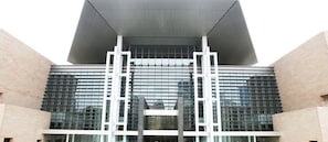 A modern building with a large glass facade and a prominent white structure in the center. - Holiday Inn Express Changsha Wuyi Plaza by IHG (Changsha)