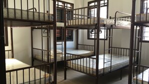 A dormitory room with bunk beds, a window with blinds, and a door. - Homey Hostel, Ipoh Town (Ipoh)