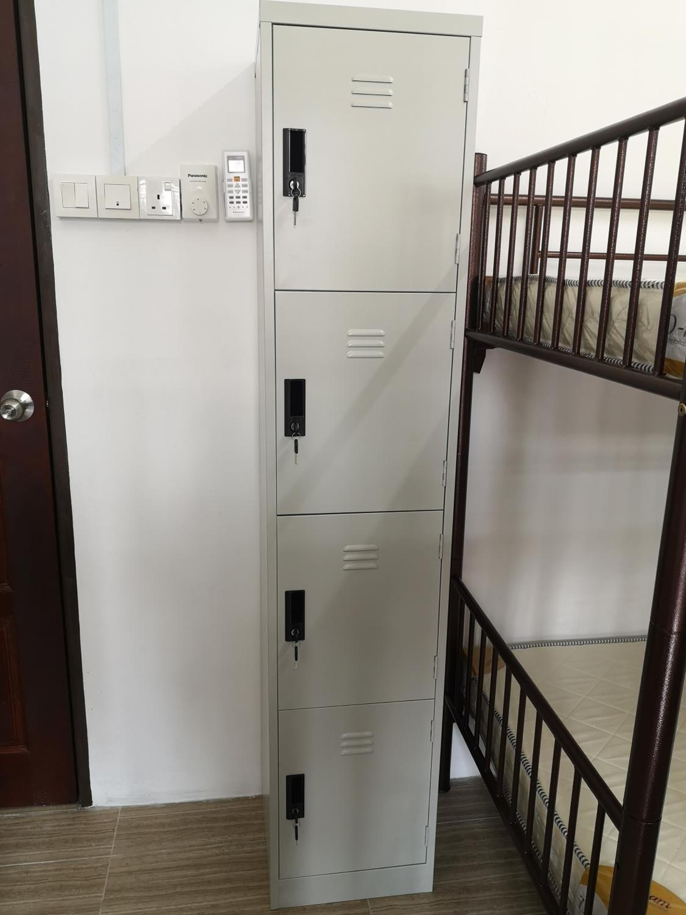 A metal filing cabinet with multiple locks and a control panel with a keypad.