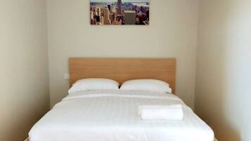 Desk, iron/ironing board, bed sheets