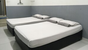 A room with two beds, a towel rack, and a window. - Ideal Hotel Sri Permaisuri Cheras (Kuala Lumpur)