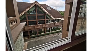 A building with a distinctive architectural style, featuring large windows and a balcony with intricate railings. - SweetSuites at Pine Crest New Manila (Quezon City)