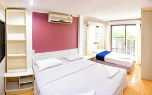 A hotel room with a large bed, a built-in wardrobe, an air conditioning unit, and a balcony with a view. - G.I Lodge by Zuzu (Pattaya)