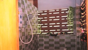 A bathroom with a checkered floor, a shower, a toilet, and a wooden partition with plants. - Center Home City (Chiang Mai)
