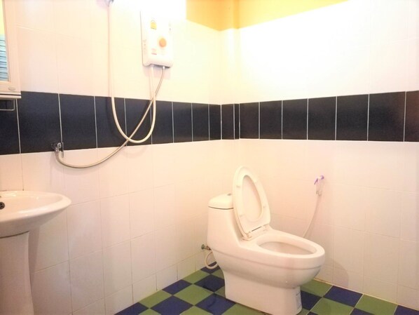Un baño con inodoro, lavabo y ducha.