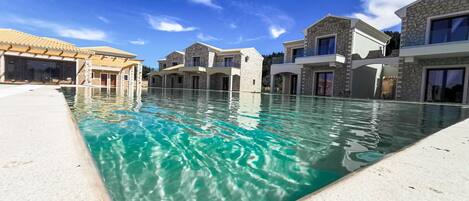 A heated pool, sun loungers