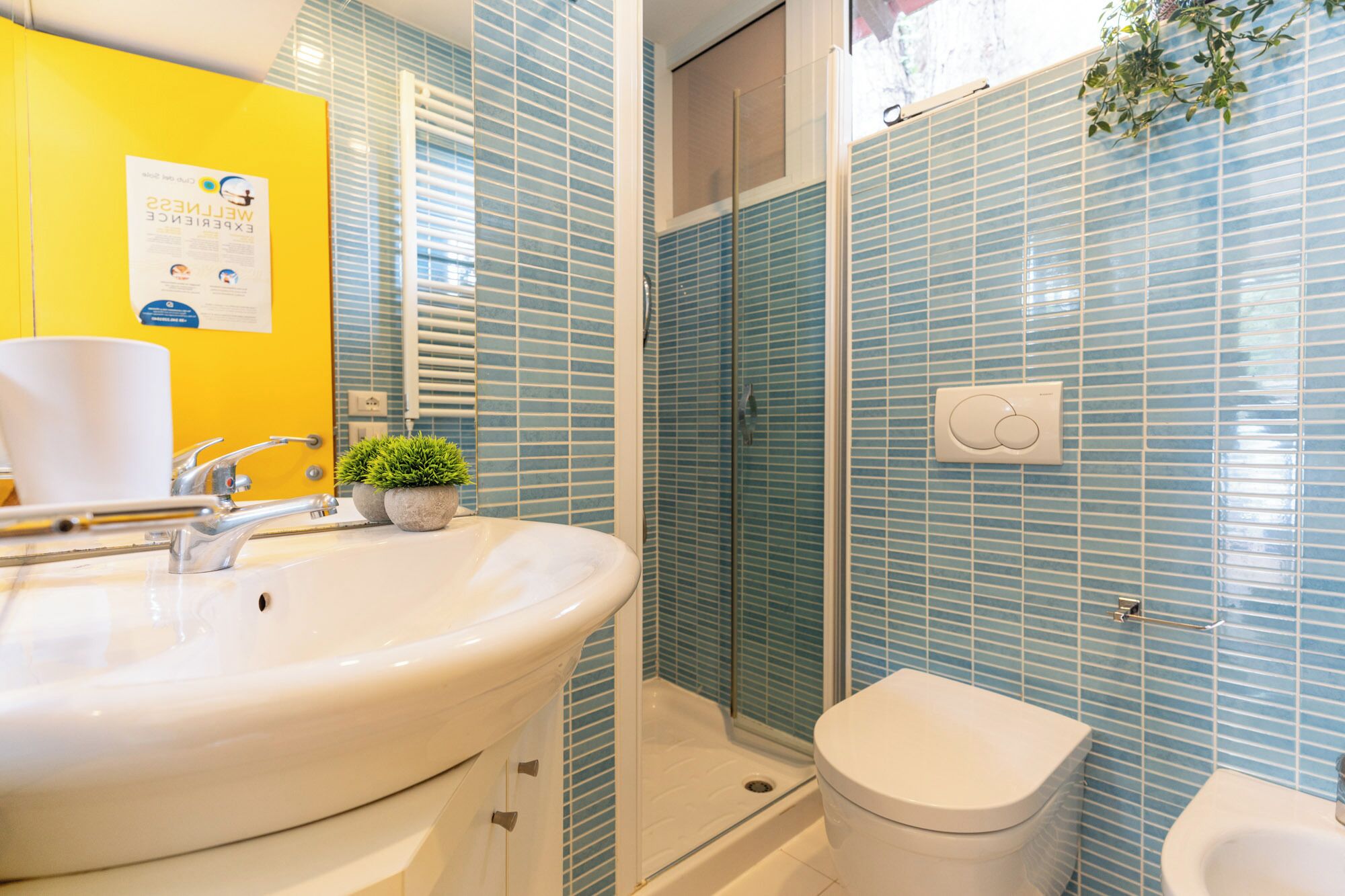 A bathroom with a sink, toilet, and shower.