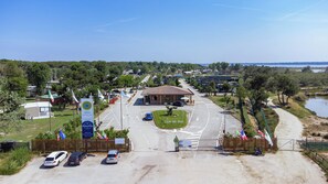 A beach resort with a central building, parking area, and a view of the beach and water. - Club Del Sole Spina Family Collection (Comacchio)