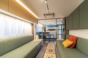 Caravan Luxury | Living area | Flat-screen TV, foosball, table tennis - Club Del Sole Adriano Family Collection (Ravenna)