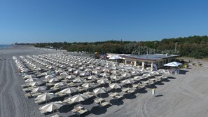 On the beach, sun loungers, beach umbrellas, beach volleyball