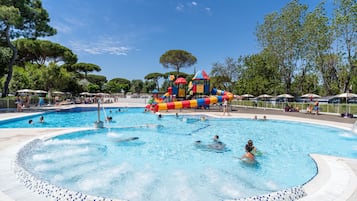 Una piscina al aire libre de temporada, sombrillas