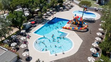 Seasonal outdoor pool, open 10:00 AM to 6:00 PM, pool umbrellas