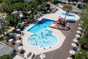 Seasonal outdoor pool, open 10:00 AM to 6:00 PM, pool umbrellas
