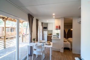 Superior Mobile Home, 2 Bedrooms | Living area | Flat-screen TV, ping pong - Club del Sole Stella del Mare Family Collection. (Castiglione della Pescaia)