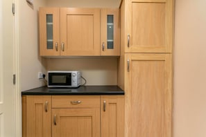 Compact kitchen area with modern amenities for basic cooking needs.