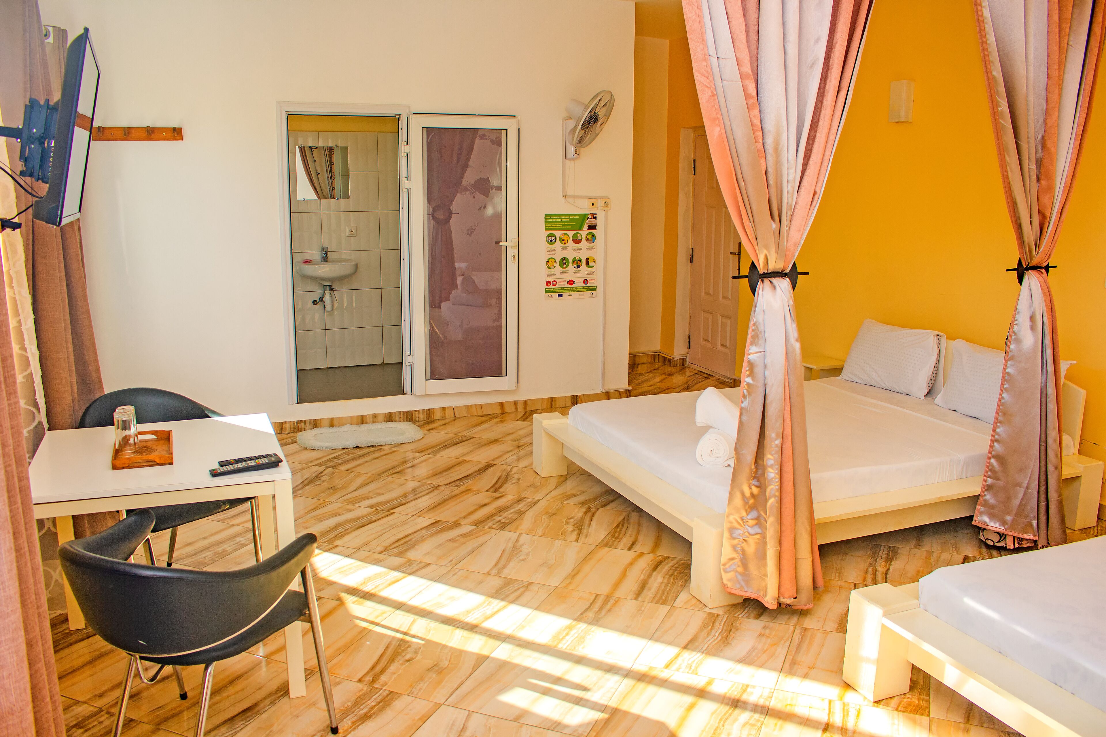 A room with a bed, a desk, and a chair.