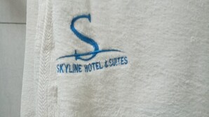 A white towel with a logo and text reading "SKYLINE HOTEL & SUITES". - Skyline Hotel & Suites (Nakuru)