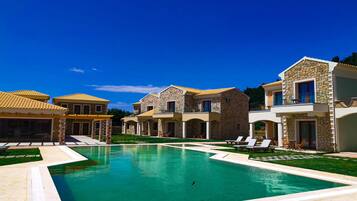 Relax by the serene pool surrounded by beautifully designed buildings with outdoor seating areas.