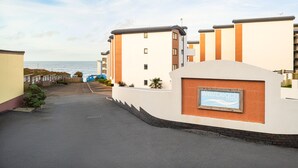 A modern residential building with a sign indicating 'Westbeach Devon'. - Westbeach Holiday Apartments (Bideford)