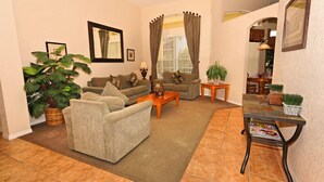 A living room with two sofas, a coffee table, a side table, and a magazine rack. - 213 BS (Davenport)